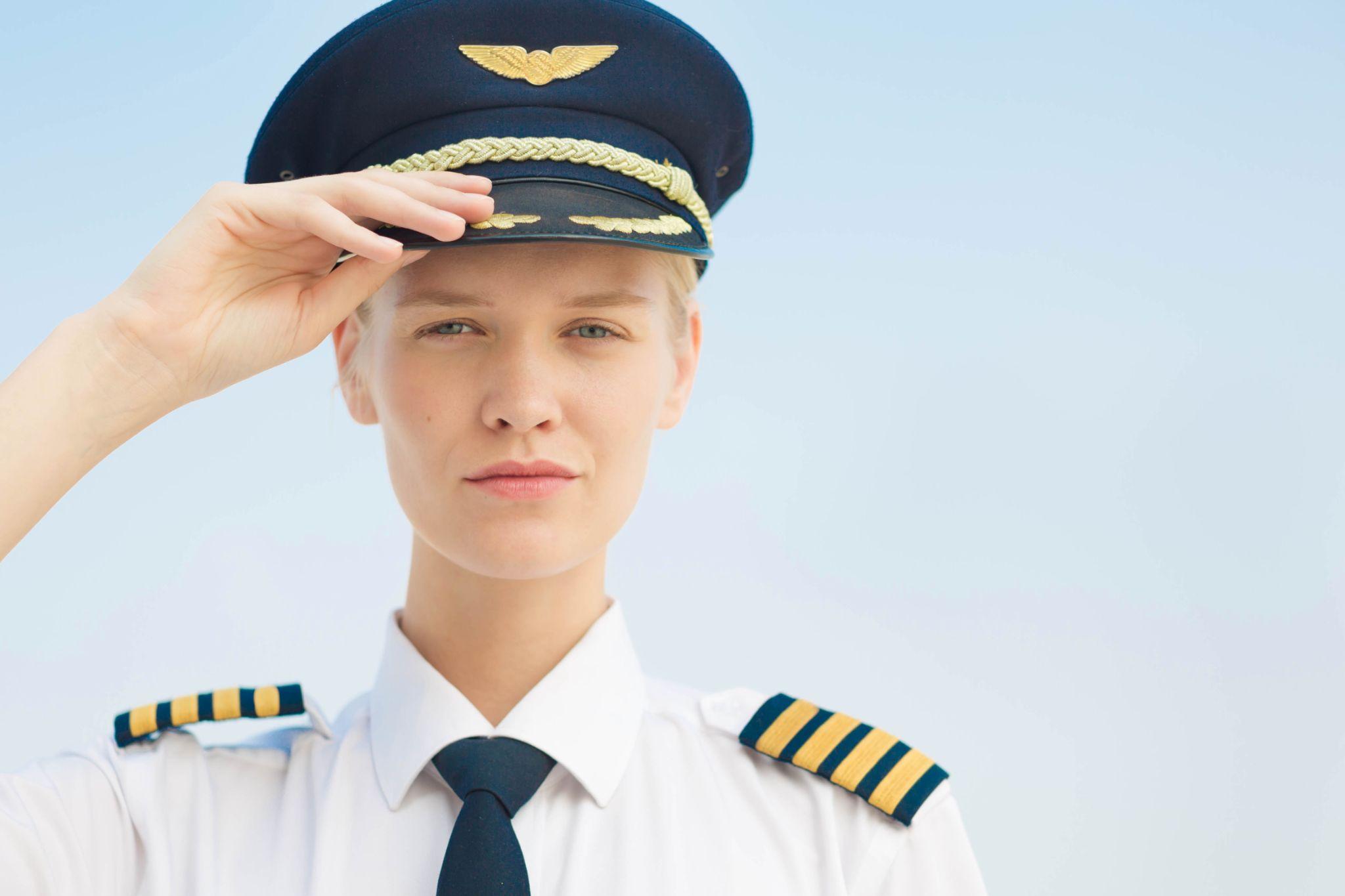 A female pilot captain at the airport.