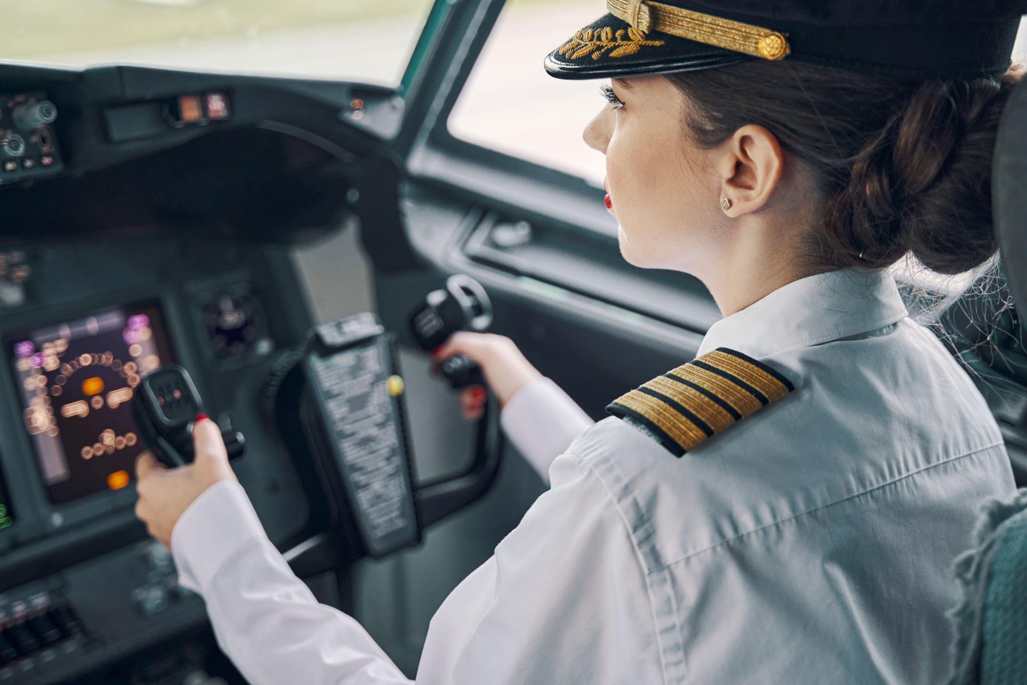 Female aviator pilot piloting an aircraft.