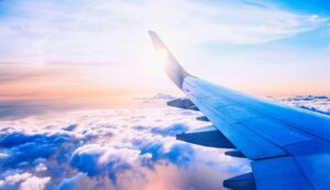 View from airplane window on the wing on sunset time.